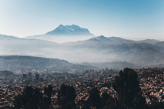 scenic viwe of the city of la paz at sunrise with the illimani  mountain in the background