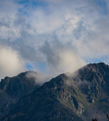 The peaks of the green mountains in the clouds
