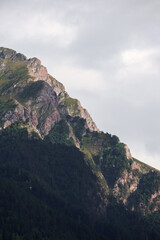 The peaks of the green mountains in the clouds