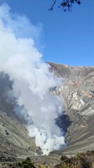 Volcanic mountain crater emitting light smoke showing power of earth and nature