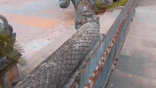 Seven headed serpent or naga statue guarding the entrance to Wat Svay Romeat Pagoda in Siem Reap, Cambodia. Shot in motion