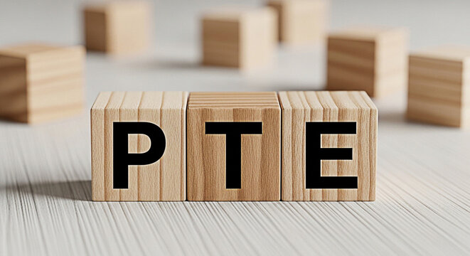 Wooden blocks spelling pte on a white wooden surface used for education and learning about language proficiency testing and preparation