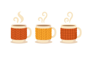 Three hot beverage mugs with textured knitted sweater sleeves in warm colors