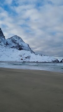 Scenic view of the winter  landscapes at Bunes Beach on a  with the mountains in the background on Lofoten Islands in Norway.

