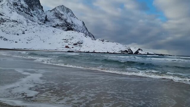 View of amazing sandy Bunes beach with sea and mountains in winter, Lofoten Islands, Norway

