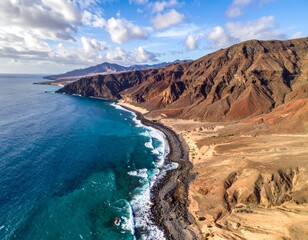 Desert landscape converges with ocean along a rugged coastal area