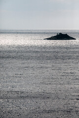 little island in the sea around rovinj in croatia on a moody day with dramatic light