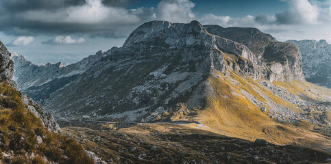 Majestic mountain landscape in Durmitor National Park, Montenegro. Sunlight illuminating vast rocky...