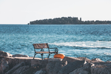 bench by the sea under pale, golden light and the istrian panorama