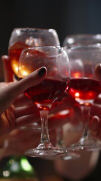 Vertical slow motion video roasted turkey on festive table camera rising to friends making toast with glasses of red wine concept thanksgiving dinner Christmas celebration family gathering cozy mood