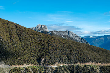 The mountain scenery of the Qinghai-Tibet Plateau, with a road winding along the mountainside