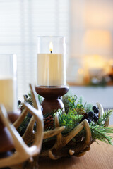Beautiful LED candles and festive decor on wooden table indoors, closeup