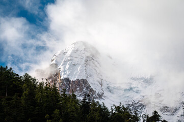 Snow capped mountains in the mist of the Qinghai Tibet Plateau