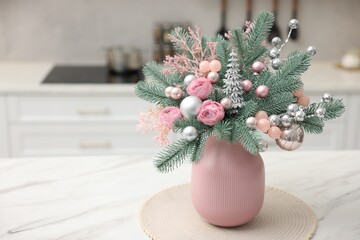 Beautiful composition with fir tree branches in vase on white marble table indoors, space for text. Winter decor