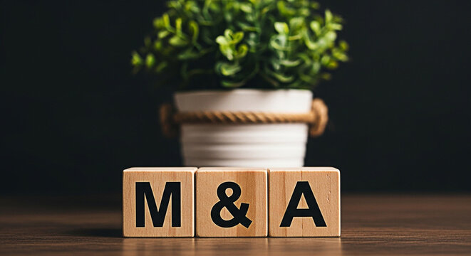 Wooden blocks spelling m&a for mergers and acquisitions concept with a plant in the background on a wooden surface for business strategy