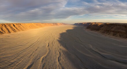 The panoramic sweep of a wide, gravel-filled wadi.