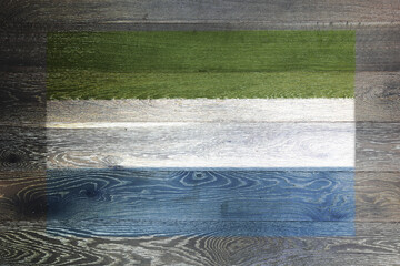 Sierra Leone flag on rustic old wood surface background