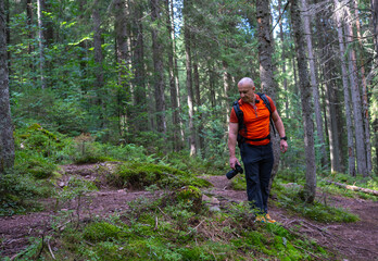 Fototapeta premium Photographer hiking in Apuseni forest