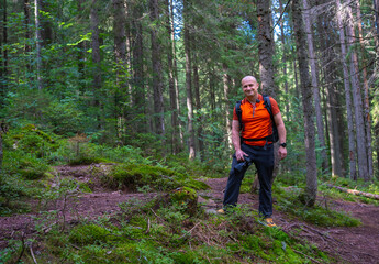 Fototapeta premium Photographer hiking in Apuseni forest