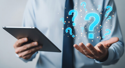 Businessman holding a tablet with holographic question marks representing inquiry and solutions