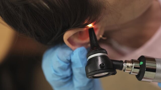 ENT doctor. Ear examination. Doctor's appointment. Slow motion. Vertical video. High quality 4k footage