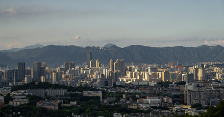 A Panoramic View of the City Skyline with Distant Mountains in the Background