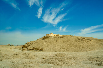 Experience the scenic journey to Valley of the Kings in Luxor Egypt, featuring desert hills and a distant structure, filmed in 2025.