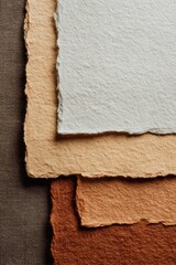 Earthy toned textured paper on dark fabric for creative design projects