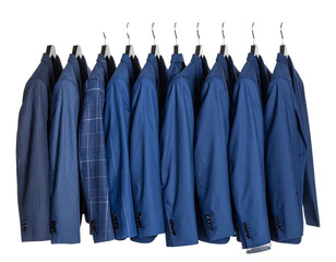 A row of suits hanging, various shades of blue, with one plaid pattern, isolated on a black background