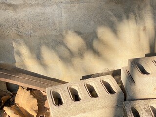 Shadow of the tree on the cement wall background with cement blocks.