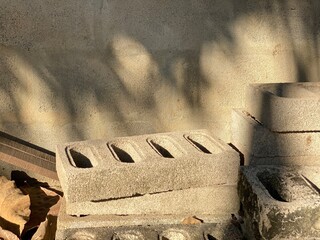 Shadow of the tree on the cement wall background with cement blocks.
