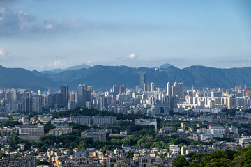 A Stunning Panoramic View of the City Skyline with Majestic Mountains in the Background
