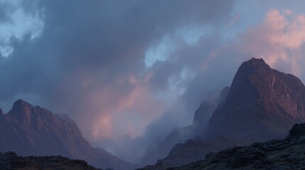 Majestic Mountain Range Under Dramatic Cloudy Sky During Sunset