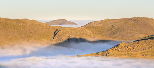 Morning light on Lake District mountains with cloud inversion looking over to Great End and Pillar. Cumbria, England.