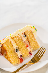 Fork resting beside layered cake slice