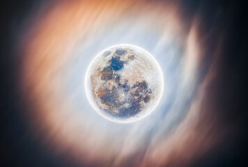 Full Moon Shining Through Clouds at Night