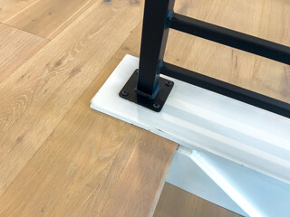 Close up stair railing detail with wooden floor