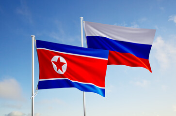 flags of russia and north korea over blue sky background.