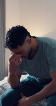 Sad, thinking or man with depression in bedroom for reflection, contemplation and emotional thought. Disappointed guy, shaking head or person with anxiety, mental health or remember mistake in house.