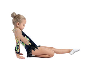Cute little girl doing gymnastic exercise on white background