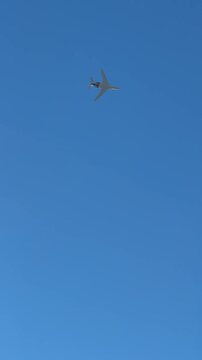 private lear jet flying in blue sky