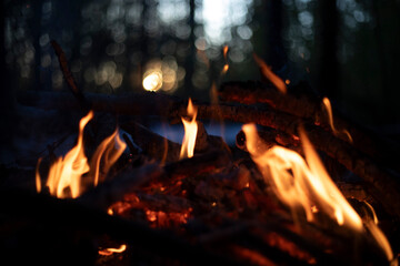 A bonfire at sunset. Flame against the sunset. Yellow flames of a bonfire.