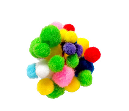 Colorful fluffy pom poms clustered together, isolated on white background, creative craft concept.