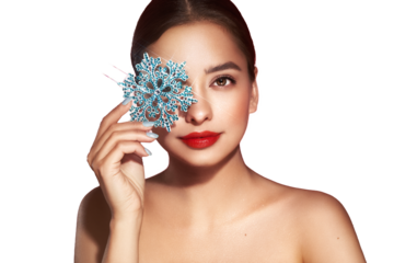 Beautiful young woman with red lipstick, shiny clean skin and face, showing glowing snowflake, near face and smiling, isolated on a transparent background. Christmas holidays concept