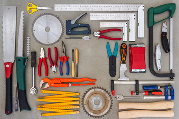 Flat lay of old hand tools on concrete background. Large collection of various rusty tools and bits...