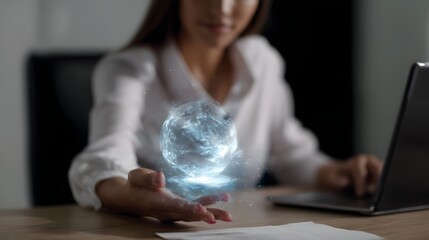 Woman projecting a glowing blue hologram sphere from her hand on a desk with a laptop