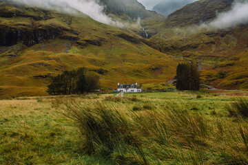 Loch Achtriochtan is a small lake in Glencoe, Scotland, famous for the iconic River Coe and the white Achnambeithach Cottage, which sits at its south end in the Scottish Highlands next to a waterfall
