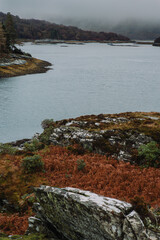 A dramatic and atmospheric photograph of the ruined medieval Castle Tioram (pronounced "Cheerum"), the former stronghold of the Clanranald branch of the MacDonalds - in Loch Moidart