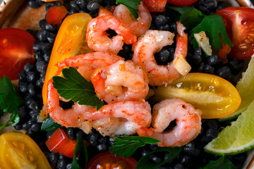 Black ptitim pasta served with shrimps and vegetables