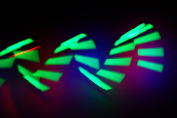 Neon Light Patterns. Abstract image of dynamic green light trails on a dark background.